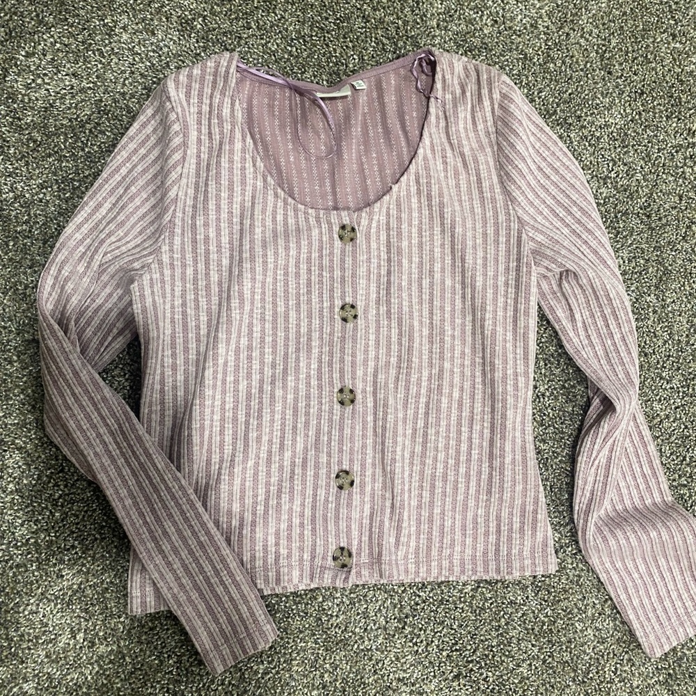 Cute pink sweater. Brown buttons down the middle